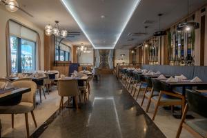 a dining room filled with tables and chairs at Armella Hill Hotel in Side