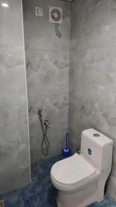 a bathroom with a toilet and a shower at Golden Stay Inn in Kovakulam +11 photos
