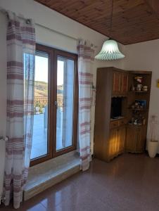 a living room with a large window with a view at Terrazza sul cielo in Bella