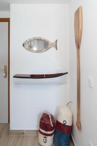 a shelf with a wooden spoon and two containers at Cullera Playa Racó in Cullera