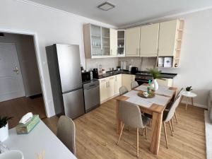 a kitchen and dining room with a table and chairs at Európa Apartman Mini in Békéscsaba