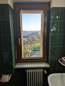 a bathroom with a window with a view of the ocean at Terrazza sul cielo in Bella +22 photos