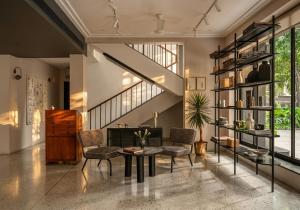 a living room with a table and chairs at Wellesley Hotel in Pune