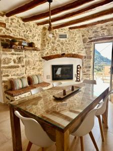 a stone room with a dining table and a fireplace at Harmony Family house in Kerames +38 photos