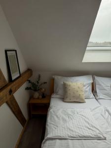 a bedroom with a bed and a window at Resort Hvozd in Krompach