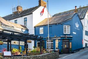 a blue and white building with a flag on a street at The Crown Hotel in Lynton