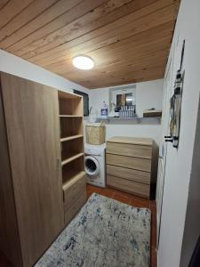 a small kitchen with a washer and dryer at Villa Magnet in Lozenets
