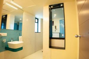 a bathroom with a sink and a mirror at Ascot Hotel in Kozhikode