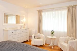a white bedroom with a bed and a chair and a dresser at 2 Bed in Upper Vobster oc-c39495 in Mells