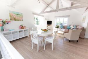 a living room with a table and chairs and a couch at 2 Bed in Upper Vobster oc-c39495 in Mells