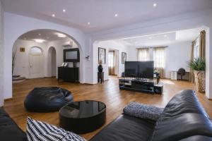 a living room with a couch and a flat screen tv at Apartment Vila Pavlovski in Bled