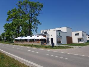 a building with umbrellas on the side of a road at Apartmány Miromar in Podivín