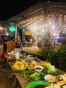 a table with a bunch of food on it at An Yen Resort in Phú Quốc