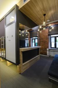 a kitchen with a bar in the middle of a room at Capsule Hotel Capsula in Moscow