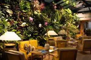 a room with a large wall of plants at Hotel Pas De Calais in Paris