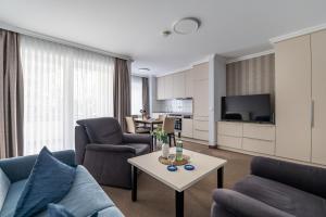 a living room with a couch and a table at K & R Appartements Binz in Binz