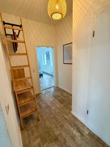 a room with a ladder and a room with a hallway at Modernes Apartment im Grünen in Kroppach