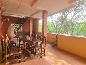 a dining room with a table and chairs at Tusker Tea County in Mal bazar