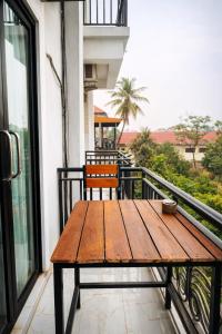 a wooden table sitting on top of a balcony at Eden De Vangvieng in Vang Vieng