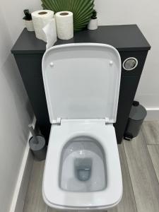 a white toilet in a bathroom with a black counter at Modern 3-Bed House in Ramsgate Close to Seafront in Ramsgate