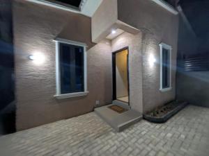 a building with a door and a window on it at The Mishkan Apartments in Kaduna