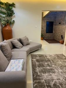 a living room with a couch and a rug at The Mishkan Apartments in Kaduna