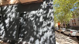 a shadow of a building with a street sign on it at Hostal Alcorcón in Alcorcón