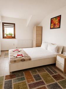 a bedroom with a large bed in a room at NATURA Garden in Cluj-Napoca