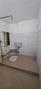 a bathroom with a blue toilet in a room at Saraswati Kunj in mayapur