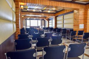 a room with rows of chairs in it at Anutri Hotels & Resorts in Jāmb