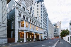 a building on a city street with tall buildings at The Cape Town Club in Cape Town