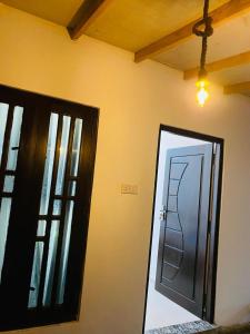 a room with a door and a ladder on the wall at LA PRINCE HOTEL and HOSTEL in Trincomalee +48 photos