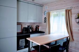 a kitchen with a table and a counter top at Tinyhaus BLÜCHER und MONTY in Stuer +16 photos
