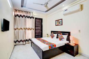 a bedroom with a bed and a window at Sarla Residency in Noida +14 photos