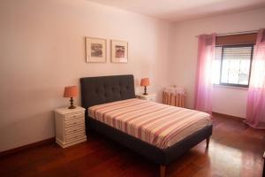a bedroom with a bed and two night stands at Casa da Serra in Quinta do Anjo +34 photos