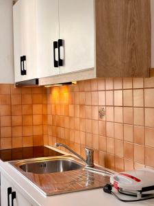 a kitchen with a sink and a counter top at Qeparo Antonio Rooms in Qeparo +88 photos