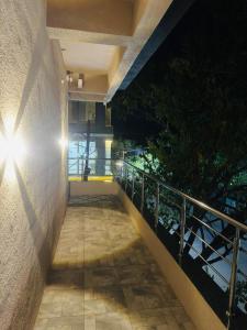 a balcony with a light on the side of a building at manoj lodge in Sangamner