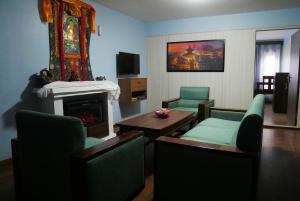 a living room with a fireplace and a table and chairs at Serenity stay in Kathmandu