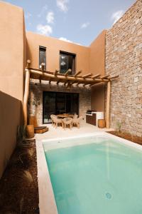 a swimming pool in front of a house at Na Xamena in La Croix-Valmer