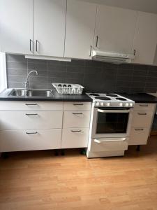 a kitchen with a sink and a stove at Charmigt boende på i centrala Helsingborg in Helsingborg +8 photos