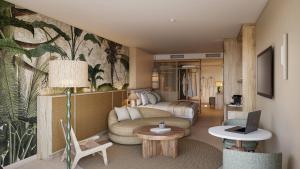 a living room with a couch and a bed at HD Sensarena - Adults Only in Costa Teguise
