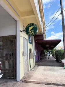 a restaurant with a sign on the side of a building at Morada do Boto in Santarém