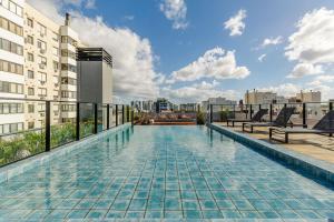 a swimming pool on the roof of a building at Soul República - Cidade Baixa in Porto Alegre
