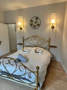 a bedroom with a bed with white sheets and pillows at Cocon détente & Jacuzzi(Balnéo) in Dieppe