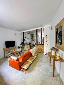 a living room with a couch and a television at Cocon détente & Jacuzzi(Balnéo) in Dieppe