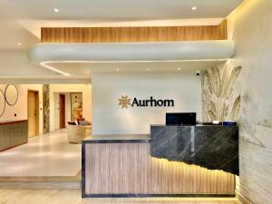 an entrance to an airport lobby with an autumn sign on the wall at Aurhom By Royal Inn in Karachi