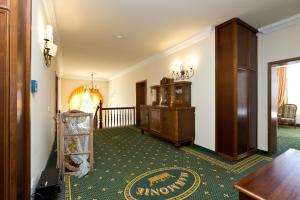 a hallway with a room with a table and a floor at Waren Müritz Hotel Harmonie in Waren +117 photos