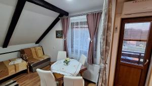 a small room with a table and chairs and a window at Guest House Family Varda Plitvice Lakes in Plitvička Jezera