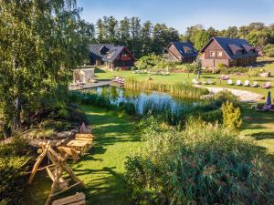 a river with a group of houses in the background at Seehotel Burg Spreewald in Byhleguhrer Kaupen