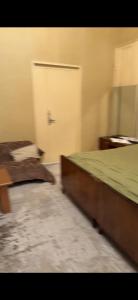 a bedroom with two beds and a white door at Vintage Stile in Ganja